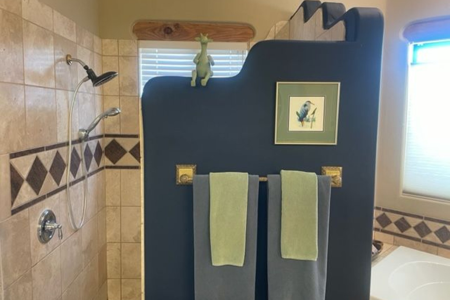 Large walk-in shower with bench.